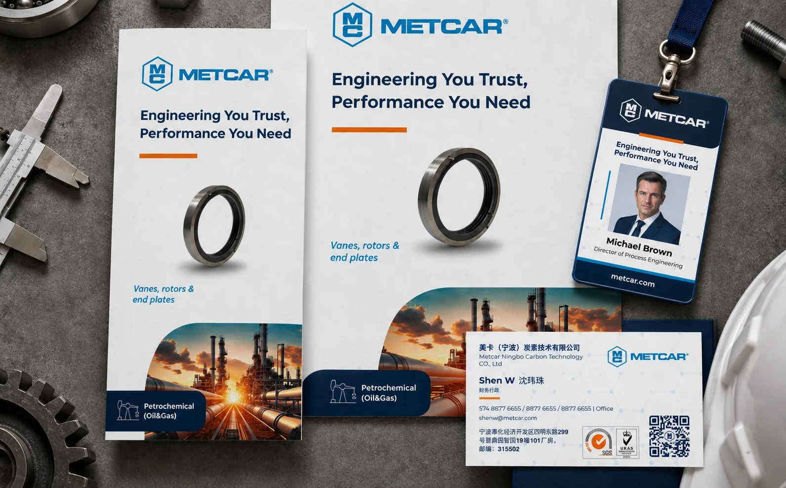 Metcar brochures, badge and business card on a workshop surface